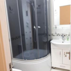 a bathroom with a shower and a sink at Hostel Sebzor in Tashkent