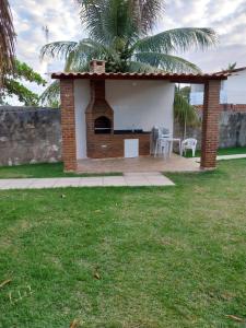 a small building with a table and chairs in a yard at Casa Mar Azul in São José da Coroa Grande +26 photos