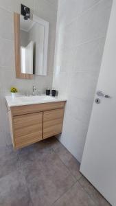 a bathroom with a sink and a mirror at PLUM APART in San Rafael