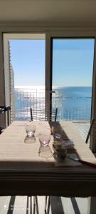 a dining table with a view of the ocean at Attico fronte mare in Martinsicuro