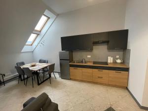 a kitchen with a table and a sink and a stove at Apartamenty Świerkowa #1 in Ząbkowice Śląskie