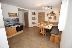 a kitchen and dining room with a wooden table at Zur STOCKERin - Ferienwohnung in Schladming +21 photos