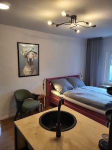 1 dormitorio con 1 cama y lavamanos en una habitación en Ruhiges Apartment & Veranda mit guter Anbindung en Bochum