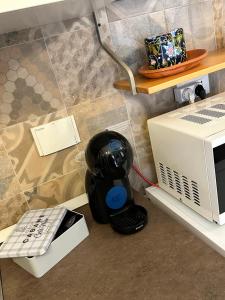 a remote control sitting next to a microwave at Casa del sasso in Bergeggi