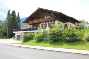 a house with solar panels on the side of the road at Zur STOCKERin - Ferienwohnung in Schladming