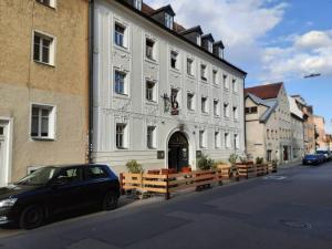 a black car parked in front of a large building at Alfred First in Regensburg