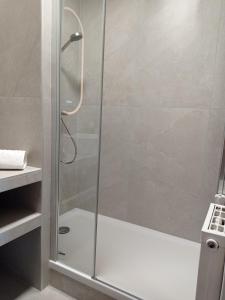 a shower with a glass door in a bathroom at BLEU CASSIS-VINTAGE -3 Ch- Magnifique vue mer- Parking gratuit et Jardin in Cassis +32 photos