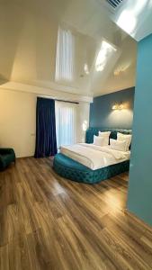 um quarto com uma cama grande e uma parede azul em Wald Hotel Lagodekhi Rooms em Lagodekhi