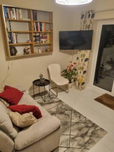 a living room with a couch and a flat screen tv at Fort William, Dripsey 