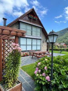 a house with a bench and a street light at Ca de Palomera Vall d’Aran in Les +23 photos