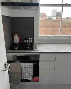a kitchen with a stove and a window at 2 Bed Apartment in Central London on 3rd floor - Newly refurbished - No lift in London