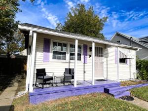 a white house with two chairs on a porch at Quiet home 15min from FQ, 10min from Trendy Bywater Neighborhood in Arabi