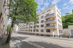 a white building on the side of a street at Super cozy apartment in the heart of Bergen city in Bergen