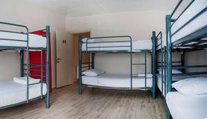 a room with three bunk beds in it at GRAND BELLA VİSTA Hostel in Istanbul