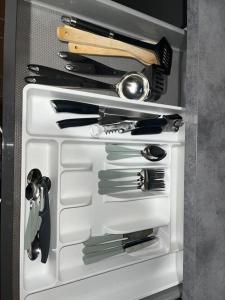 a drawer filled with utensils in a refrigerator at Maison Confort Stationnement Privatif 6 pers in Échirolles