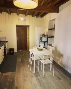 a kitchen with a table and chairs in a room at Casa Vilar (Taboadela-Ourense) in Taboadela