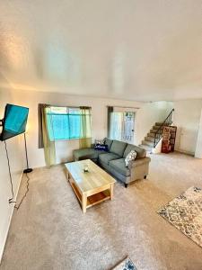 a living room with a couch and a coffee table at Charming Townhouse w/ Yard + BBQ in San Jose