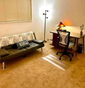 a living room with a desk and a couch and a chair at Charming Townhouse w/ Yard + BBQ in San Jose
