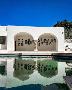 a white building with a pool of water at Si Brahim studio piscine, Sidi Bou Saïd in Sidi Bou Saïd