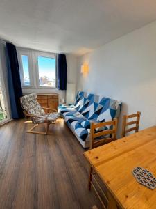 a living room with a couch and a table at Happy Yeti Avoriaz in Avoriaz