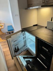 an empty refrigerator with its door open in a kitchen at Happy Yeti Avoriaz in Avoriaz +7 photos