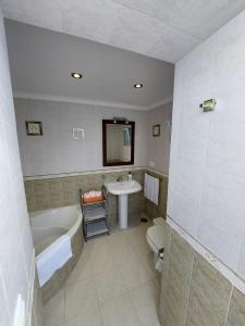 a bathroom with a tub and a sink and a toilet at CASA JARO in Sierra de Yeguas
