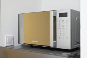 a microwave sitting on top of a shelf at Apartman N&D in Banja Luka