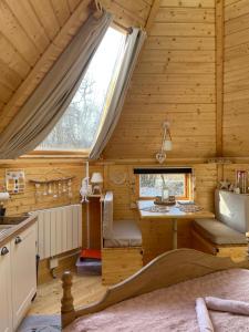 a kitchen in a log cabin with a window at Cabane, Kota Désiré in Saint Die