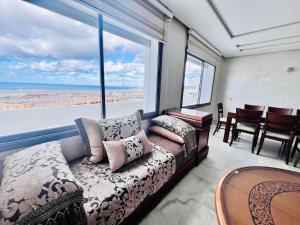 uma sala de estar com um sofá e uma grande janela em welcome to the beautiful view em Tânger