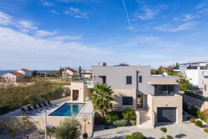 an aerial view of a villa with a swimming pool at Villa Roca with heated pool and sauna in Privlaka