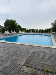 a large swimming pool with chairs on a patio at Lighthouse Golf & Spa Resort F79 in Balchik