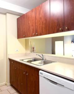 una cocina con fregadero y armarios de madera en Gorgeous 2 Bedroom apartment in NYC! en Nueva York