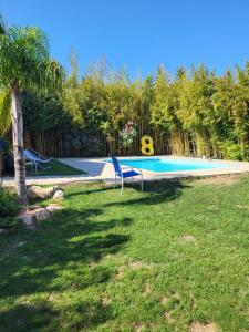 a swimming pool with two chairs in a yard at Maison avec jardin arboré in Saint-Nazaire