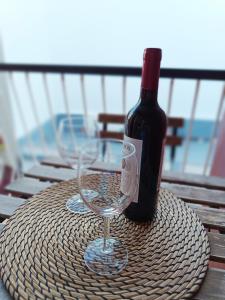 a bottle of wine sitting on a table with a glass at Apartamento Meraki in Santa Cruz de Tenerife