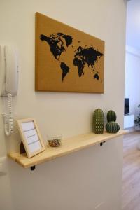 a wooden shelf with a world map on the wall at Politecnico Bovisa university apartment in Milan