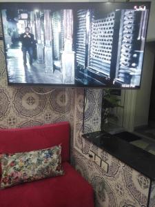 sala de estar con sofá rojo y TV en Appartement du lux très propre bien équipé au cœur de la ville nouvelle, en Meknès