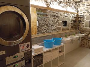 a bathroom with two sinks and a large microwave at Abeiro da loba in Madelos