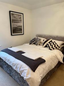 a large bed with pillows on it in a bedroom at Detached Pet Friendly Cottage, 2 parking spaces in Norwich
