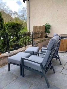 a group of chairs sitting on a patio at Luxurious & Tranquil staycation - w/ Hot Tub! in Burneside