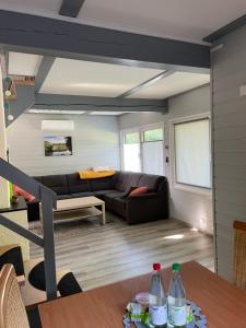 a living room with a couch and a table at All inclusive Ferienhaus JULYN , Seepark in Kirchheim