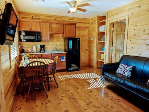 a living room with a couch and a table and a kitchen at Kingman KOA in Kingman
