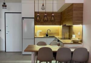 a kitchen with a table and chairs and a kitchen with a counter at Mountain Dream Bjelašnica in Bjelašnica