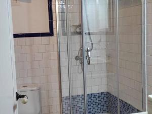 a bathroom with a glass shower with a toilet at GRH Tarraco - city center in Tarragona