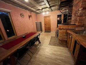 a kitchen with a counter and a bar with stools at Pirts māja Lilijas in Baldone +10 photos