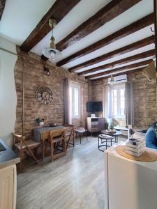 a kitchen and living room with a table and chairs at Casa Collage in Corfu Town