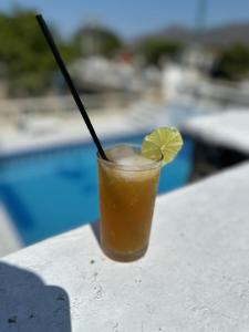 a drink sitting on a table next to a pool at SGH Castillo Aqua in Santa Marta