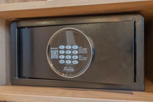 a microwave oven sitting on top of a shelf at Yuna Porte-Maillot - ApartHotel in Paris