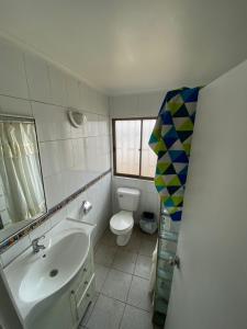 a bathroom with a sink and a toilet at Casa Quintero in Quintero