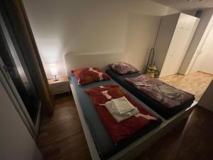 two beds in a small room with a tv at New Business Apartment Nr.21 in Dresden