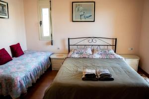 a bedroom with two beds with shoes on it at Fani's Family House in Ierápetra